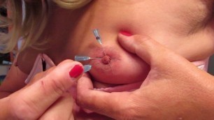 Sissy putting needles in her own nipples 2