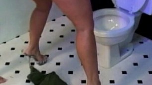 Wavy haired slut enjoys giving blowy while dude sitting on the toilet